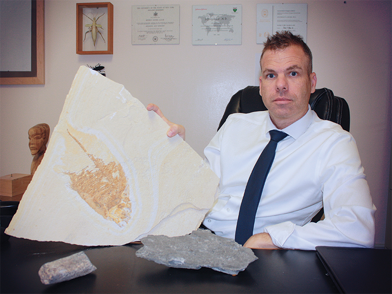 Image of Dr. Lazar, MD, with fossil