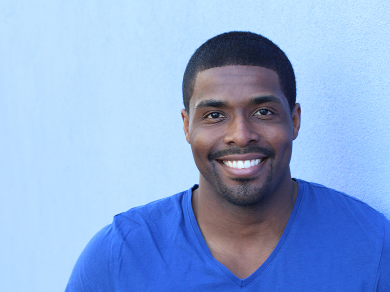 Image of man smiling after free oral cancer screening